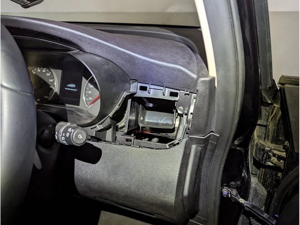 Remove the change box. Unclip the driver-side front panel held by plastic clips. Unplug the 4-pin green connector to completely remove it.