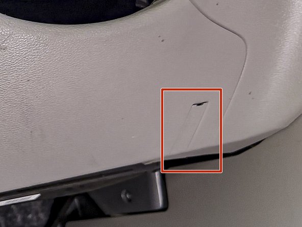 Release this access cover and remove the phillips head screw located behind it.