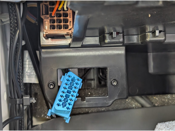 Unclip and remove the vehicle’s OBD-port from its mounting bracket