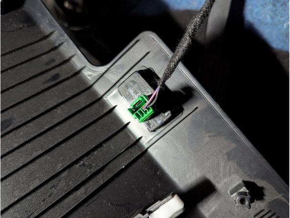 Remove the change box. Unclip the driver-side front panel held by plastic clips. Unplug the 4-pin green connector to completely remove it.