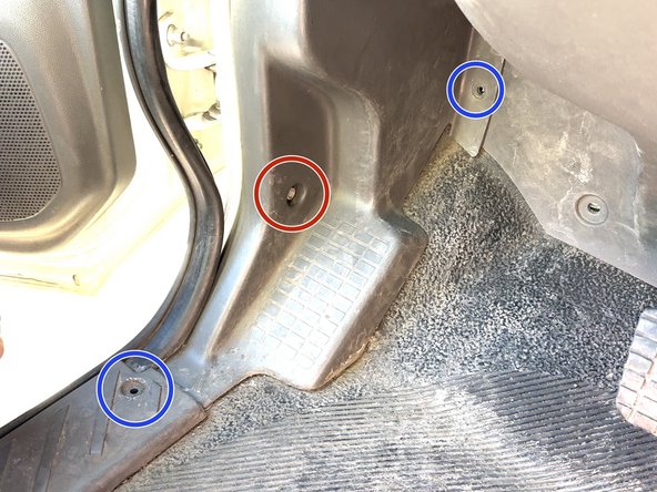 Remove (1) 13mm fastener from the kick panel area.