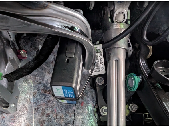 Secure the Geotab device to the bracket, using at least two cable ties.