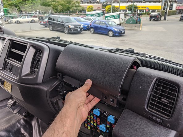 Remove the upper passenger-side dash panel by removing the two 10 mm bolts.