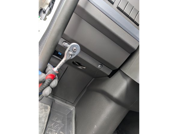 Remove the two screws of the left footwell panel.