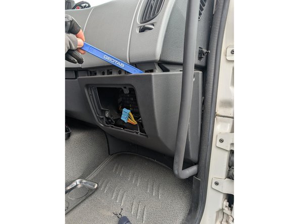 Use a panel removal or similar tool to unclip and remove the middle interior panel.