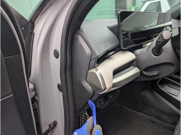 Unclip and remove the panel with a panel removal tool.