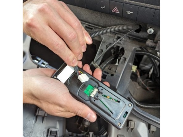 Unplug the in-cabin controller from its original vehicle connected harness.