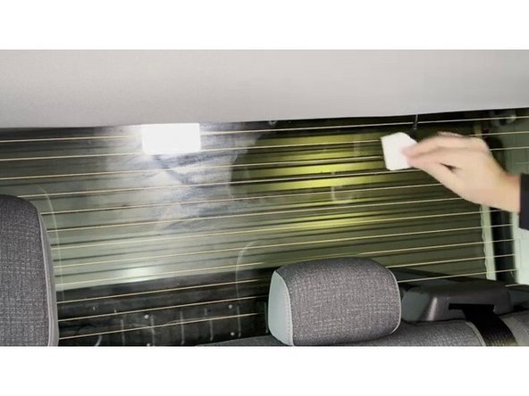 Identify the mounting location on the rear window. Choose a spot that is not obstructed by defrost lines. If the vehicle has a sliding rear window, place the camera to the side where it will not make contact with the sliding window.