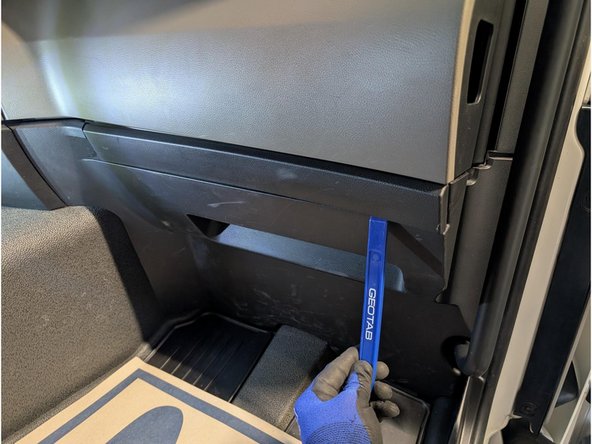 Use a panel removal tool to unclip and remove the cover below the top panel of the dashboard.