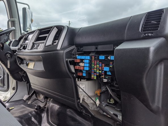 Remove the lower passenger-side dash panel. It is held in place by clips only.