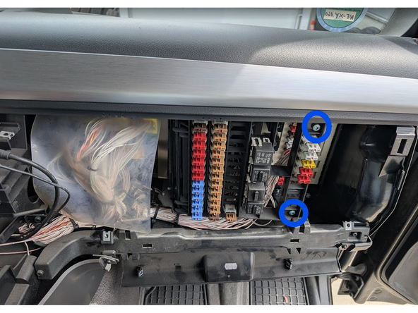 Unscrew the two screws on the right side of the fuse panel and gently set it aside.