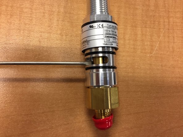 Slide the collar up to expose the adjustment shaft inside the hydraulic sensor.