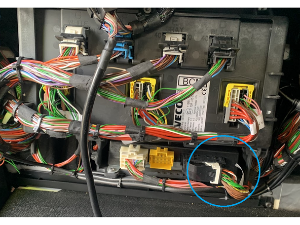 Find the orange and white twisted pair located on the black plug