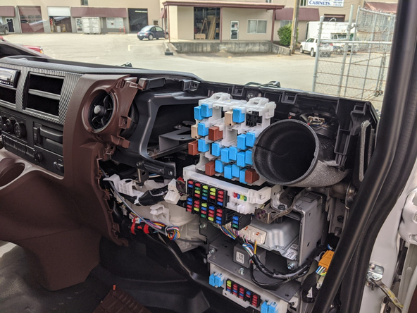 Remove the upper passenger-side dash panel by removing the two 10 mm bolts.