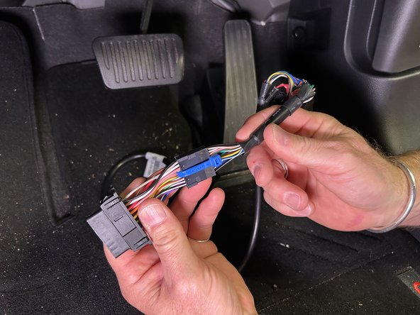 Insert the adapter number 6 into the OBD bracket. Push the harness with the molex connector end through the front of the Adapter, until it locks.