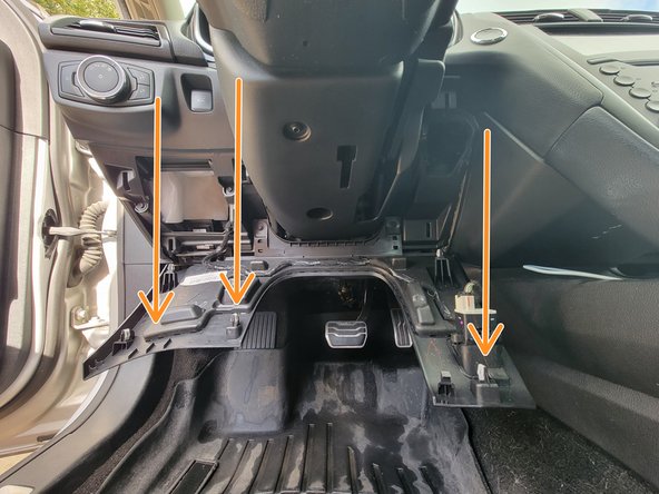 Release the lower dash panel by pulling down from the top