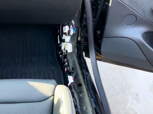 Remove the sill/kick panel to the right of the passenger seat by pulling up firmly to release the clips.