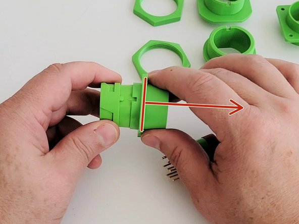 Remove the adapter from the connector housing by sliding it back.