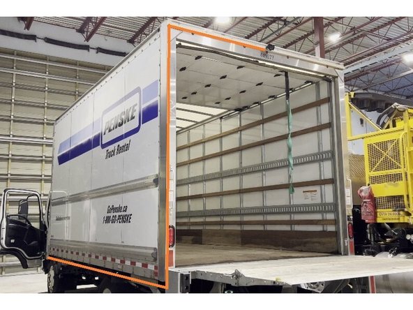 Run the rear camera cable along the vehicle frame from the rear mounting point toward the cab, keeping it tight against the chassis.