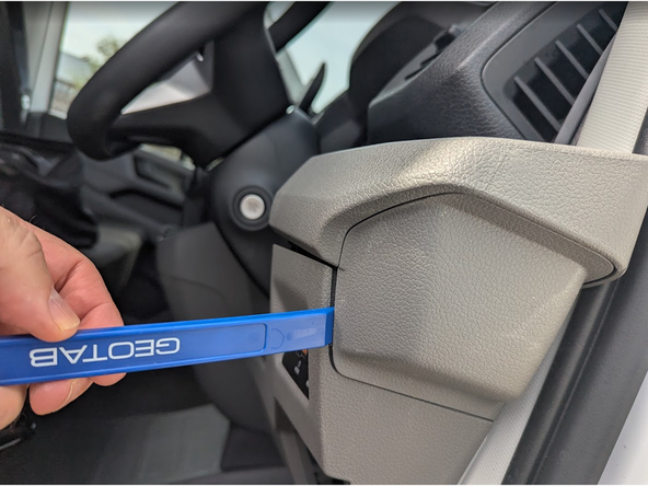 Unclip and remove the panel with a panel removal tool.