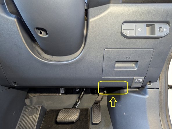 Locate the diagnostics port in the driver footwell behind the panel as shown.