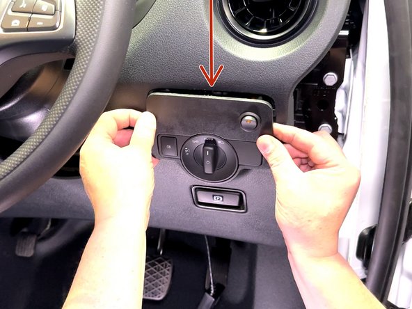 Using a panel tool, remove the light switch panel.