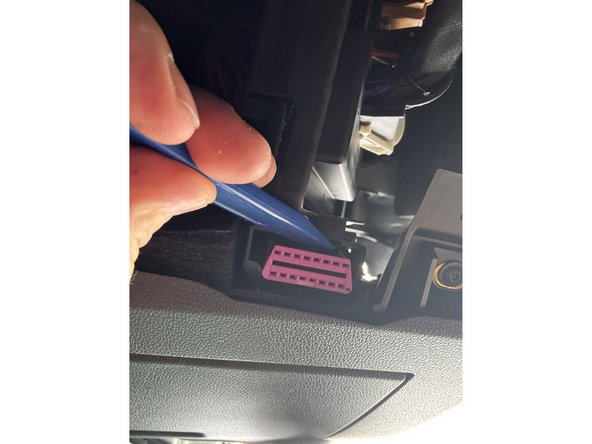 Use a suitable tool to unclip the OBD-Port from its mounting bracket