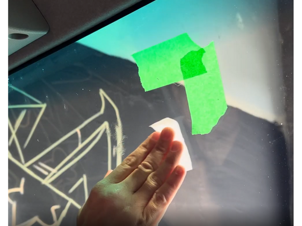 Use the provided alcohol wipe to thoroughly clean the mounting area on the windshield. Let the alcohol evaporate completely before proceeding.