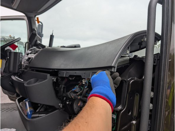 Use a Torx driver to remove the two screws, then unclip and remove the upper dashboard panel.