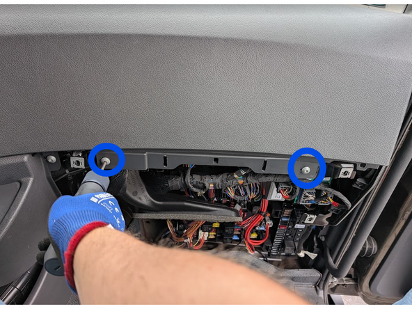 Use a Torx driver to remove the two screws, then unclip and remove the upper dashboard panel.