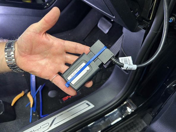 Secure the device to the harness with included cable tie.