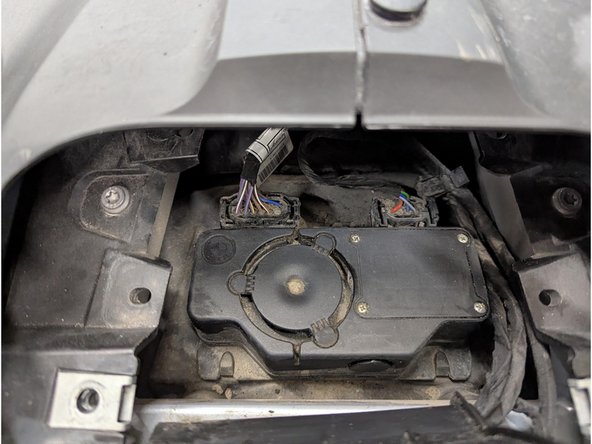 Remove the 2 x expanding rivets using a flat screwdriver or an appropriate removal tool then pull the cover outwards.