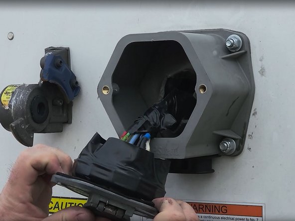 Remove the bolts that secure the nose box connector plate to the housing and then carefully pull the nose box connector plate away from the housing.