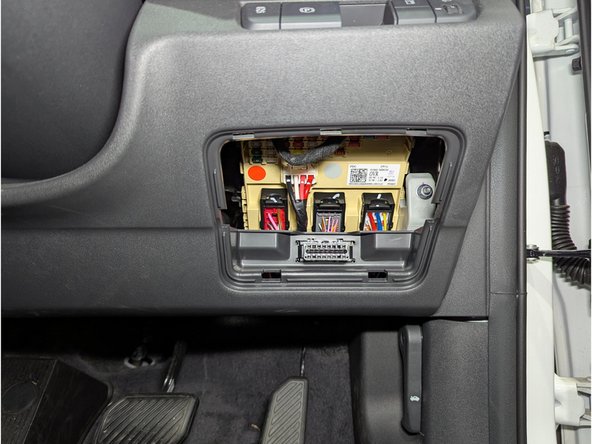 Remove the fuse panel cover to gain access to the diagnostic port.