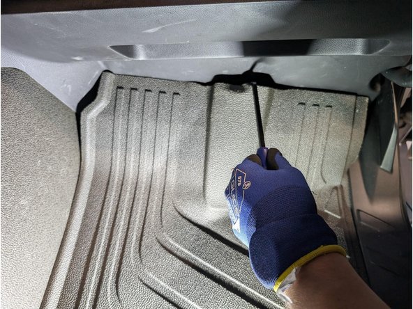 Carefully move the vehicle carpet aside