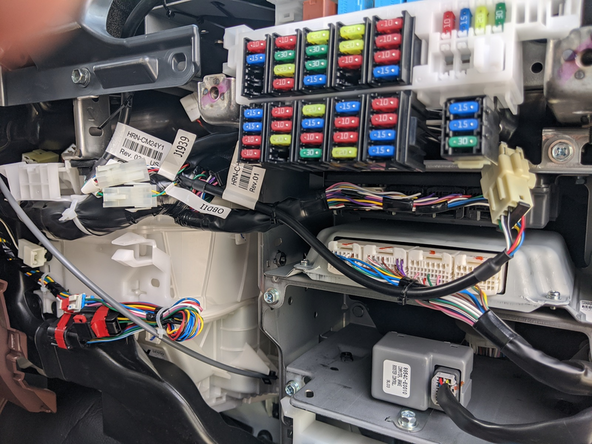 Neatly run the GO device and cabling to the top dash to the left of the fuse box. Mount the GO device to the factory dash bracket above the fuse box.