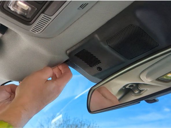 Route the cable between the headliner and roof towards the A-pillar.