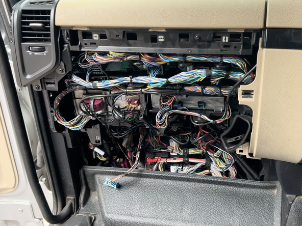 Use a T30 torx driver to remove the screw securing the ASAM control module.
