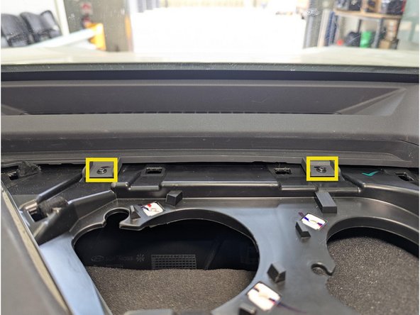 Remove the 2 x Phillips screws under the center channel speaker cover as shown.