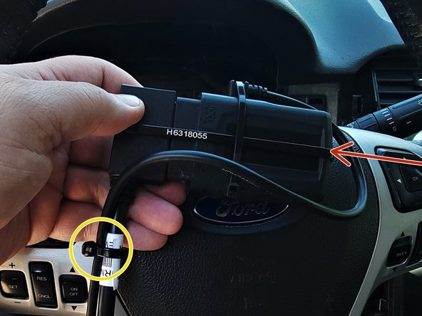 Secure the device to the harness using the included cable tie.