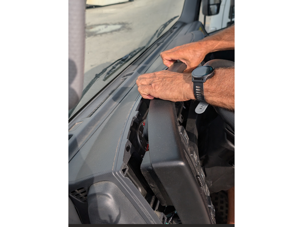 Unclip the dashboard trim with either your hands or a panel removal tool.