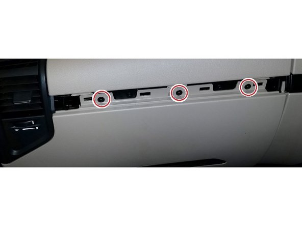 Use a size T20 Torx-driver to remove the three screws, then unclip and remove the bottom panel of the dashboard.