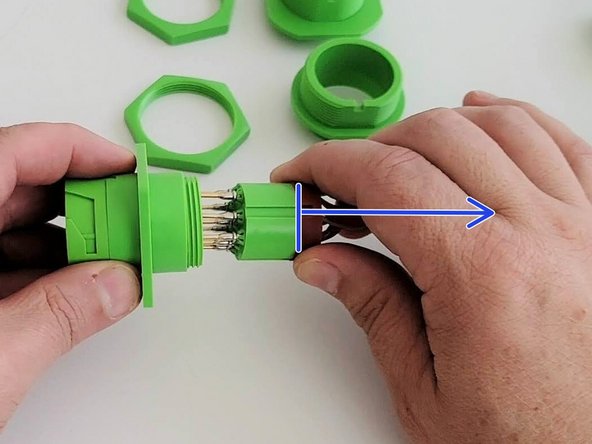 Pull the connector housing and adapter assembly away from the connector cartridge and harness.