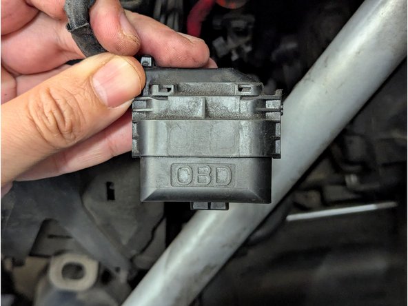 Locate the diagnostic connector and remove the protective cap.