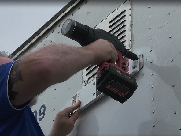 Secure the device using the blind rivet and an appropriate rivet gun.