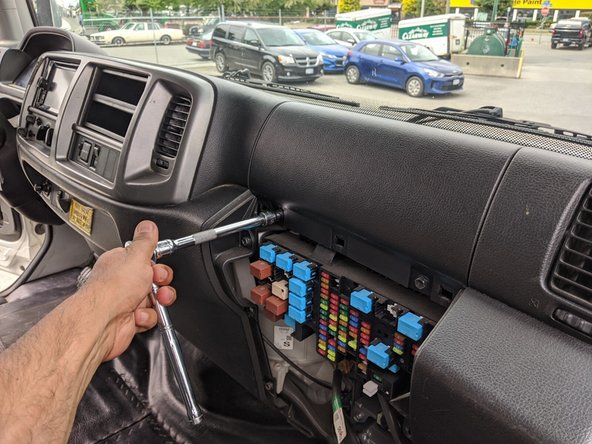 Remove the upper passenger-side dash panel by removing the two 10 mm bolts.