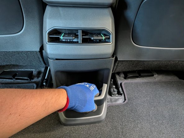 Remove the rear console cover.