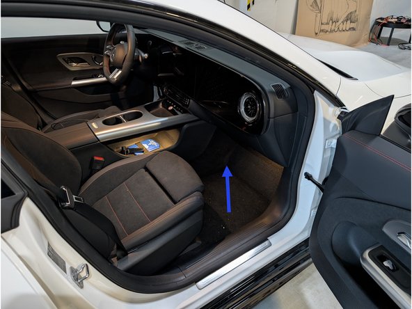 The vehicle's fuse box and low voltage battery can be found on the passenger side below the carpet.