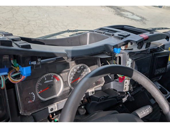 Place the dash cover on top of the dashboard as shown.