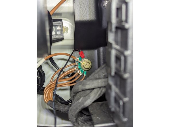 Route the white connector of the the HRN-CW03K3-A harness behind the fuse block. Attach the ring terminal of the BLACK wire (GROUND) as shown.